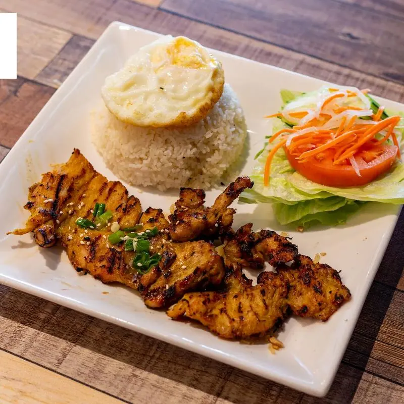 Grilled chicken served with salad and rice at Pho Mama Fremont